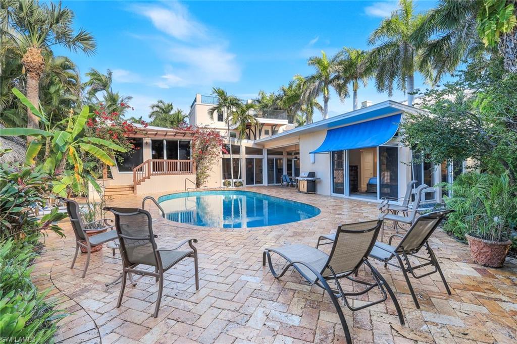 210 Central Avenue Naples, FL 34102 - Photo 3 of 50 a view of a house with swimming pool and sitting area