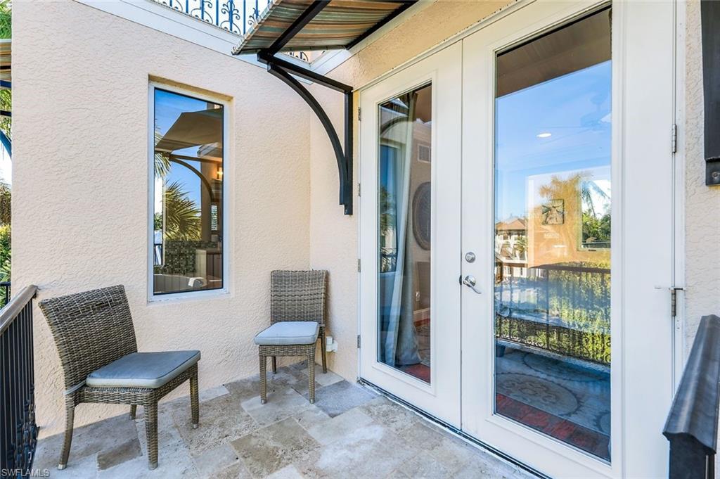 210 Central Avenue Naples, FL 34102 - Photo 31 of 50 a view of a hallway with furniture and a entryway