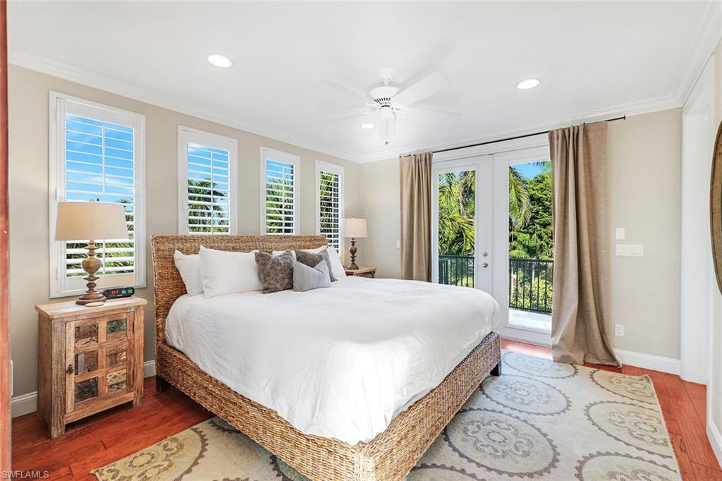 210 Central Avenue Naples, FL 34102 - Photo 34 of 50 a bedroom with a large bed and a large window