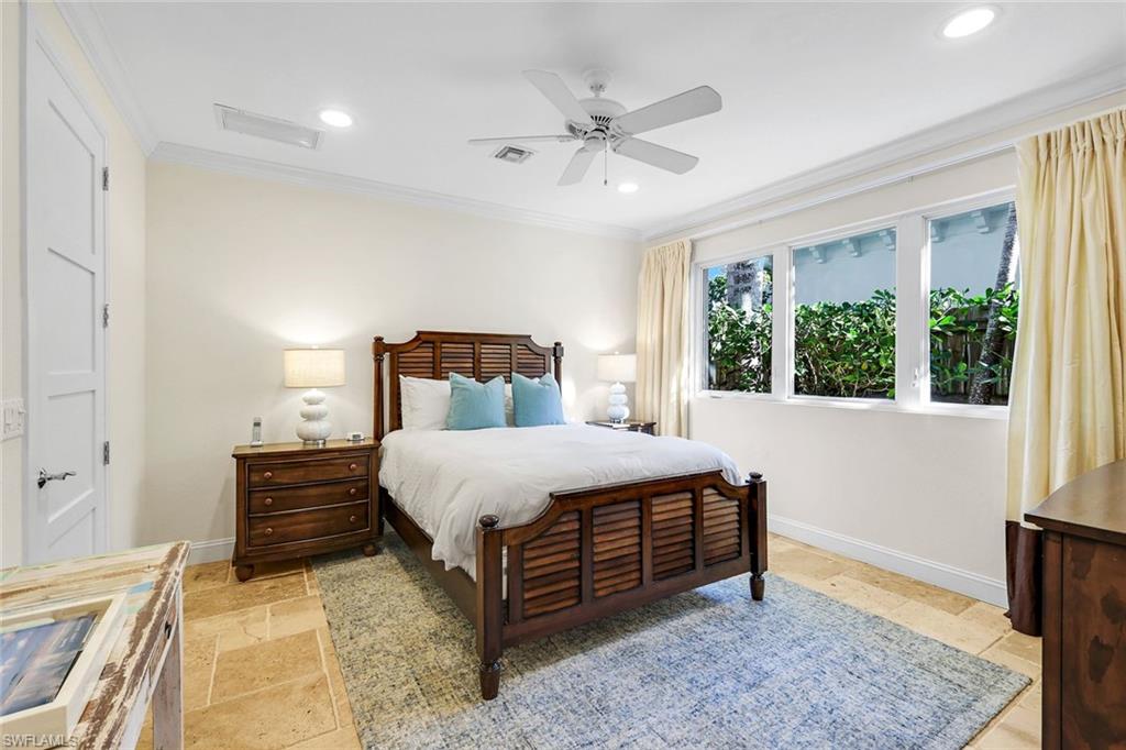 210 Central Avenue Naples, FL 34102 - Photo 38 of 50 a bedroom with a bed and wooden floor