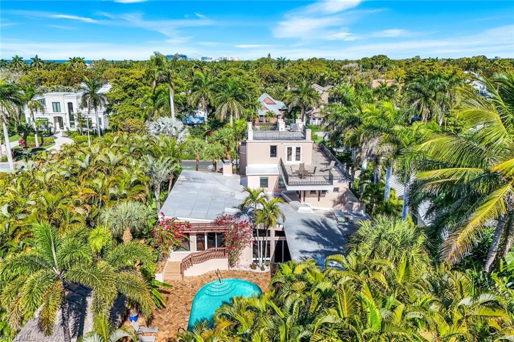 210 Central Avenue Naples, FL 34102 - Photo 48 of 50 an aerial view of residential houses with outdoor space and trees
