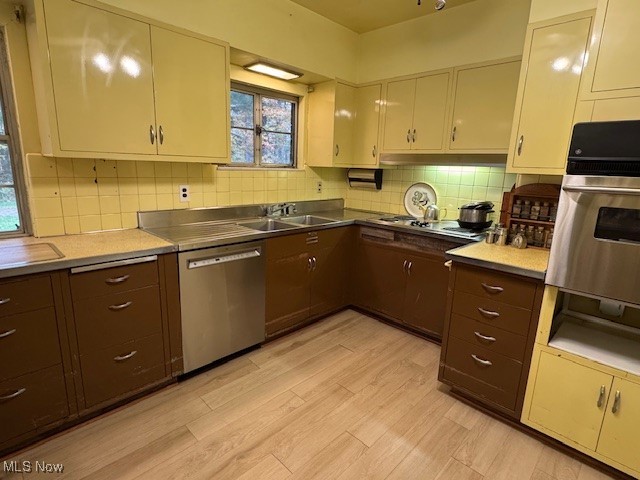 19345 Ridge Road North Royalton, OH 44133 - Photo 37 of 47 Kitchen featuring backsplash, stainless steel appliances, light wood-style flooring, and light countertops
