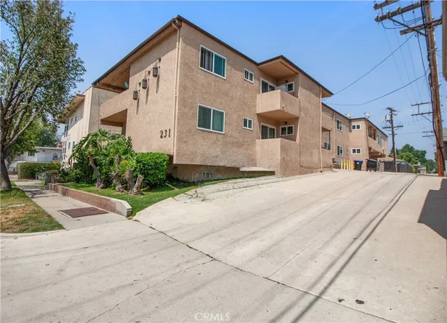 a view of a white house with a yard