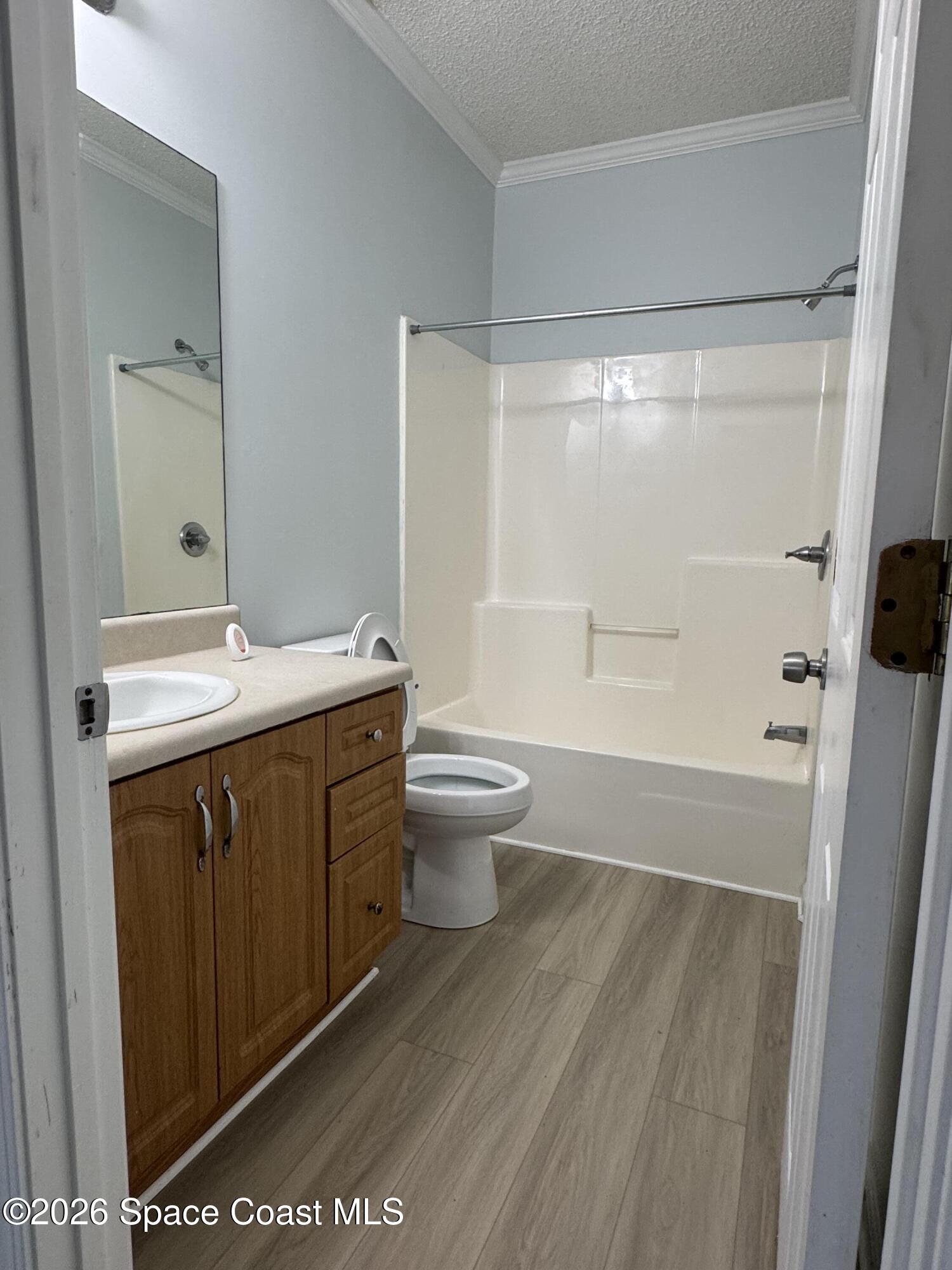 1130 Grapefruit Road Southeast Palm Bay, FL 32909 - Photo 13 of 14 a bathroom with a sink a toilet and shower