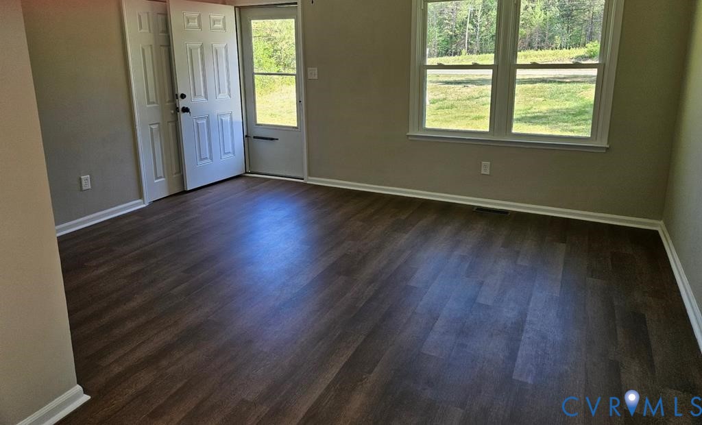 27368 Prince Edward Highway Rice, VA 23966 - Photo 2 of 18 an empty room with wooden floor and windows