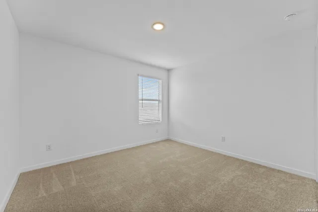 an empty room with a empty space and windows