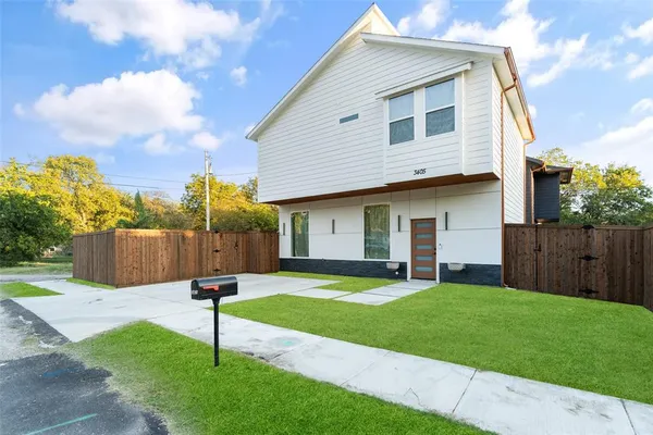 a view of empty room with wooden floor and window