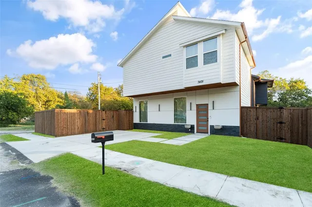 a view of empty room with wooden floor and window