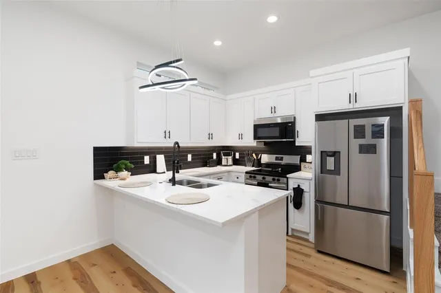 a kitchen with sink a microwave a stove and refrigerator