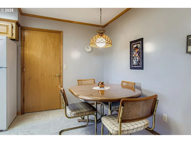 a view of a dining room with a table and chairs