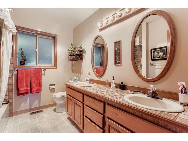 a bathroom with a double vanity sink and a mirror