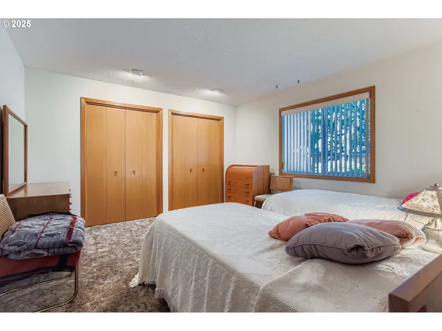 a bedroom with a bed and a large mirror