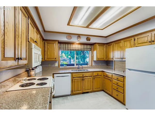 a kitchen with a sink stove and refrigerator