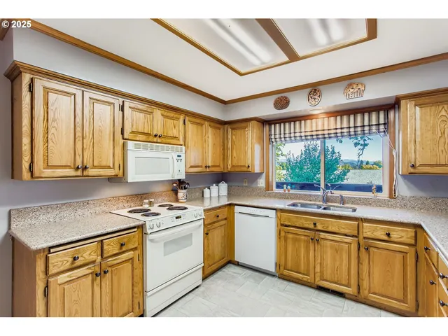 a kitchen with stainless steel appliances granite countertop a stove sink and cabinets