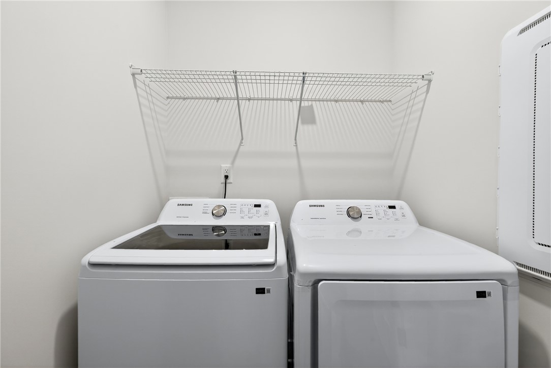 128 Whitman Way Easley, SC 29642 - Photo 24 of 34 This dedicated laundry space features convenient appliances and practical overhead storage.