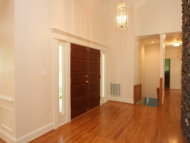 8216 Inverstone Lane Raleigh, NC 27606 - Photo 3 of 25 Mahogany front door opens to gleaming hardwoods and soaring ceilings in this entry foyer. Foyer