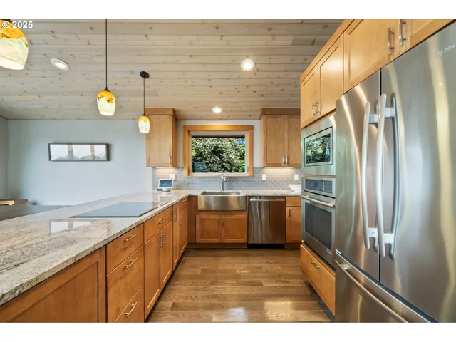 a kitchen with a refrigerator and microwave