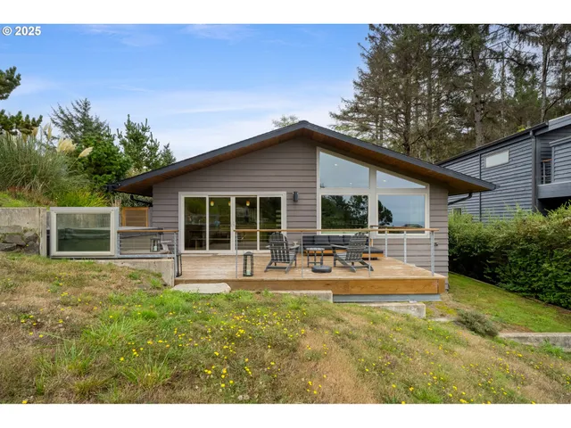 a front view of a house with patio and garden