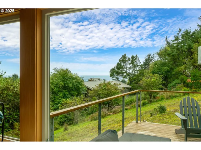 a view of a balcony with lake view and a floor to ceiling window