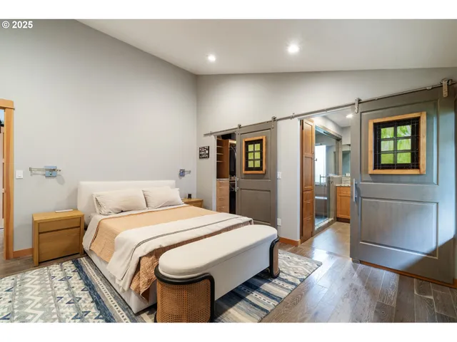 a spacious bedroom with a bed and a dresser