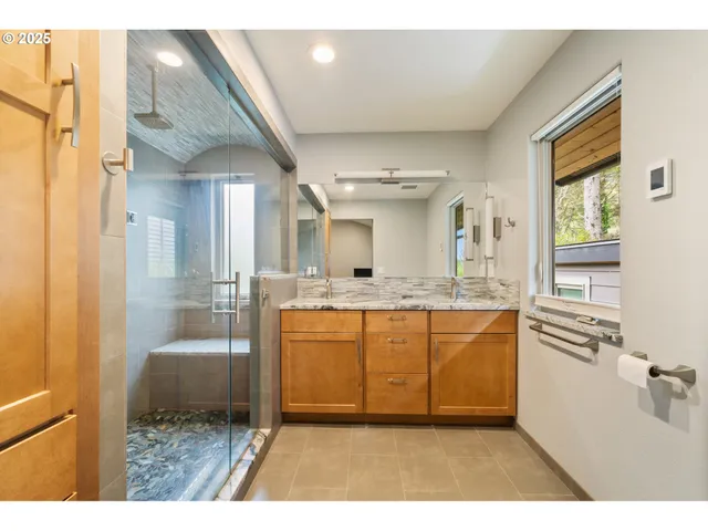 a bathroom with a tub sink and mirror