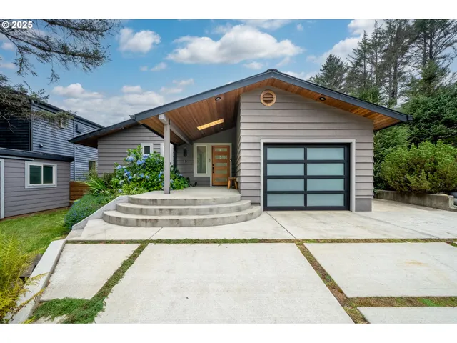 a front view of a house with a garden