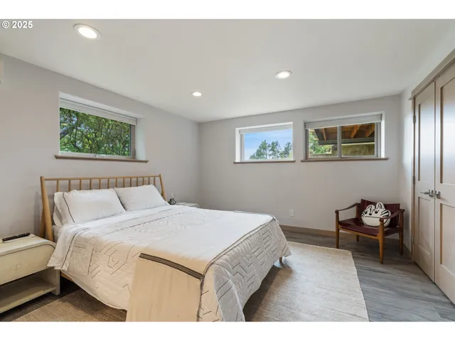 a spacious bedroom with a bed and a couch