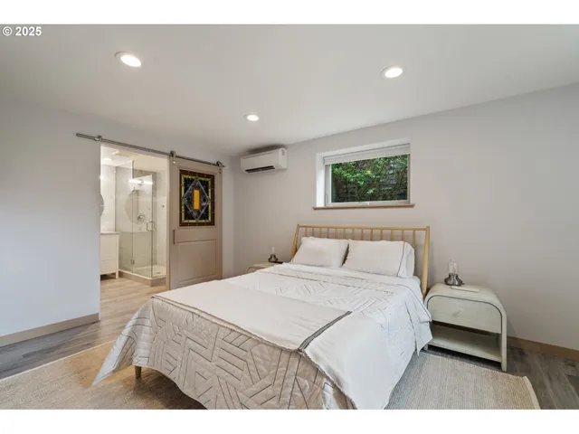 a bedroom with a bed and a painting on the wall