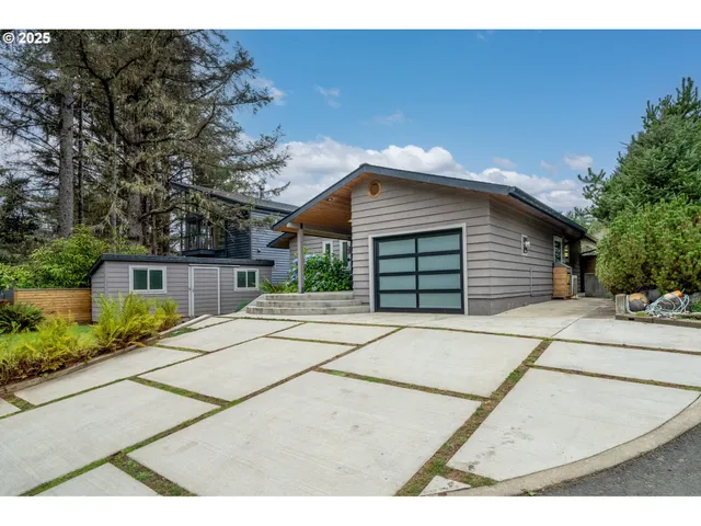 a front view of a house with a garden