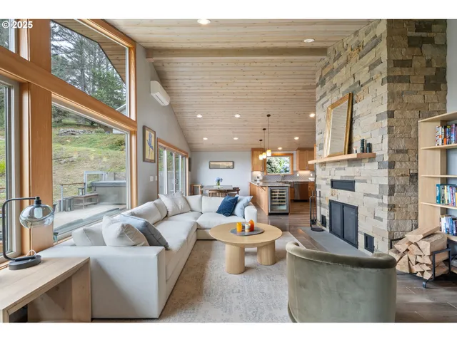 a living room with fireplace furniture and a large window