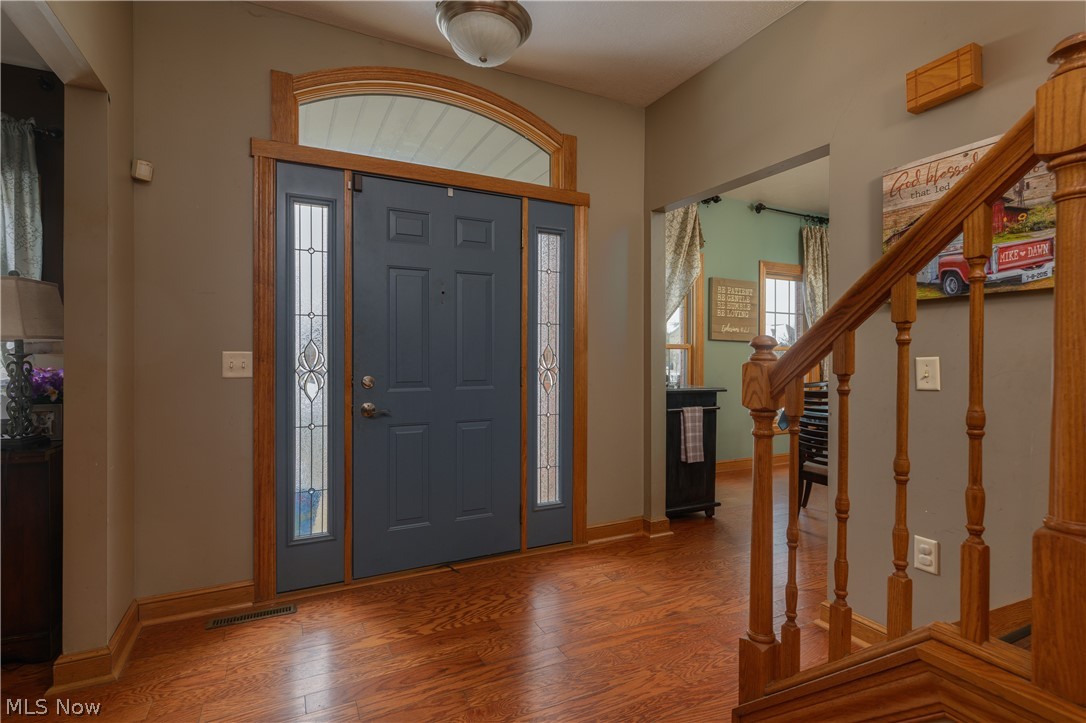 806 Forrest Ridge Drive Dover, OH 44622 - Photo 7 of 36 Foyer entrance featuring stairs and wood finished floors