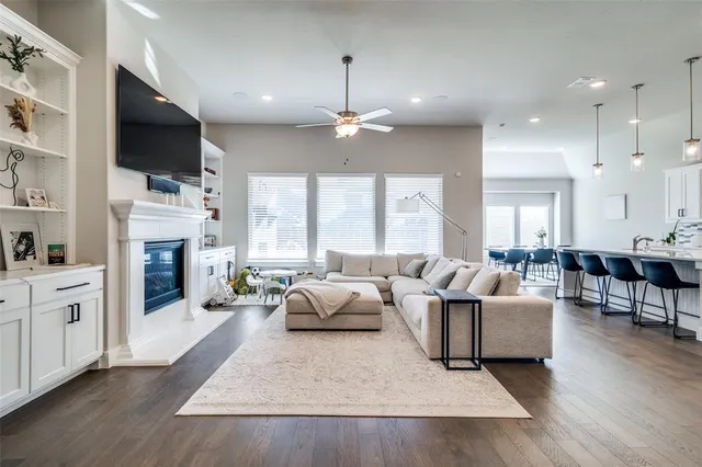a living room with furniture a fireplace and a flat screen tv