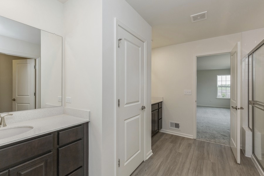 3616 Edelweiss Road Elgin, IL 60124 - Photo 14 of 26 a bathroom with a sink and a mirror