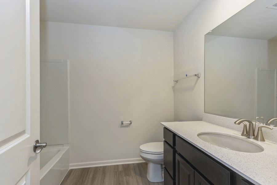 3616 Edelweiss Road Elgin, IL 60124 - Photo 19 of 26 a bathroom with a granite countertop sink toilet and a mirror