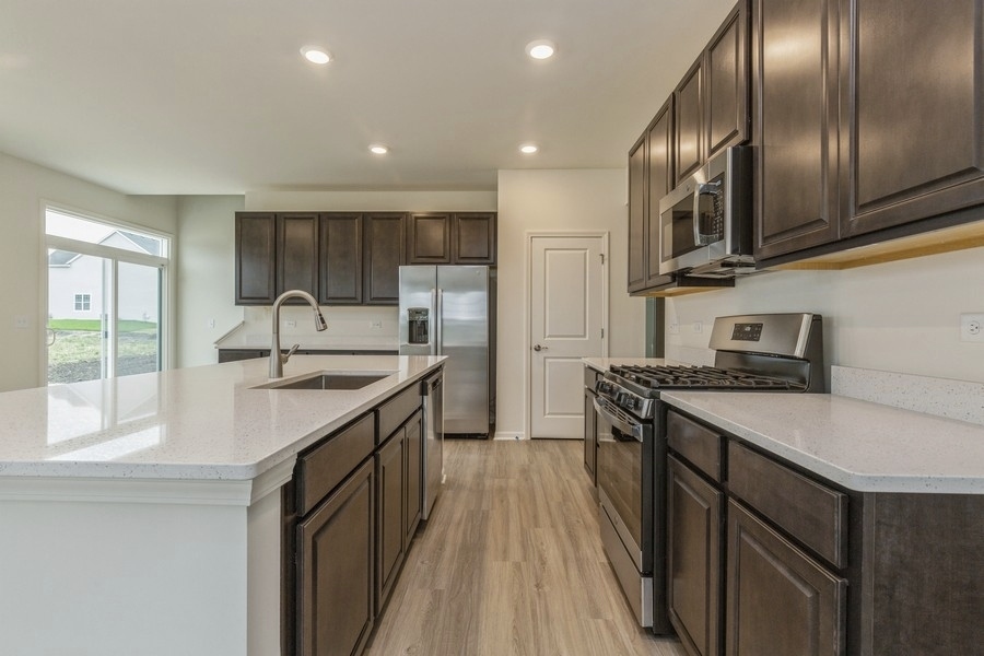 3616 Edelweiss Road Elgin, IL 60124 - Photo 8 of 26 a kitchen with stainless steel appliances granite countertop a sink stove and refrigerator