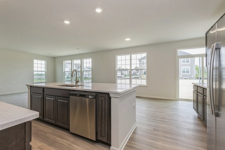 3616 Edelweiss Road Elgin, IL 60124 - Photo 10 of 26 a kitchen with stainless steel appliances granite countertop a stove a sink dishwasher a refrigerator and a wooden cabinets