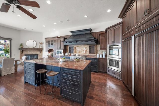 a dining room with furniture a chandelier and wooden floor