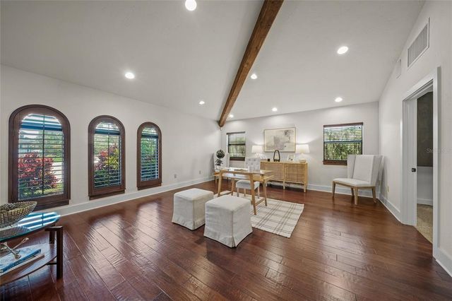 a view of a patio with table and chairs potted plants and a large tree