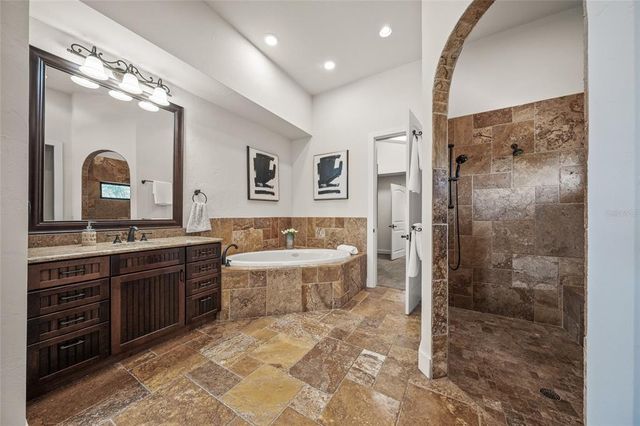 a front view of house with a yard and potted plants