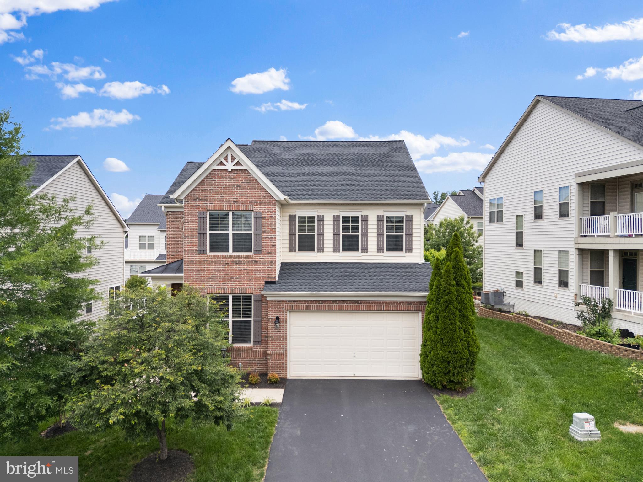 42694 Chisholm Drive Broadlands, VA 20148 - Photo 1 of 50 a front view of a house with a yard