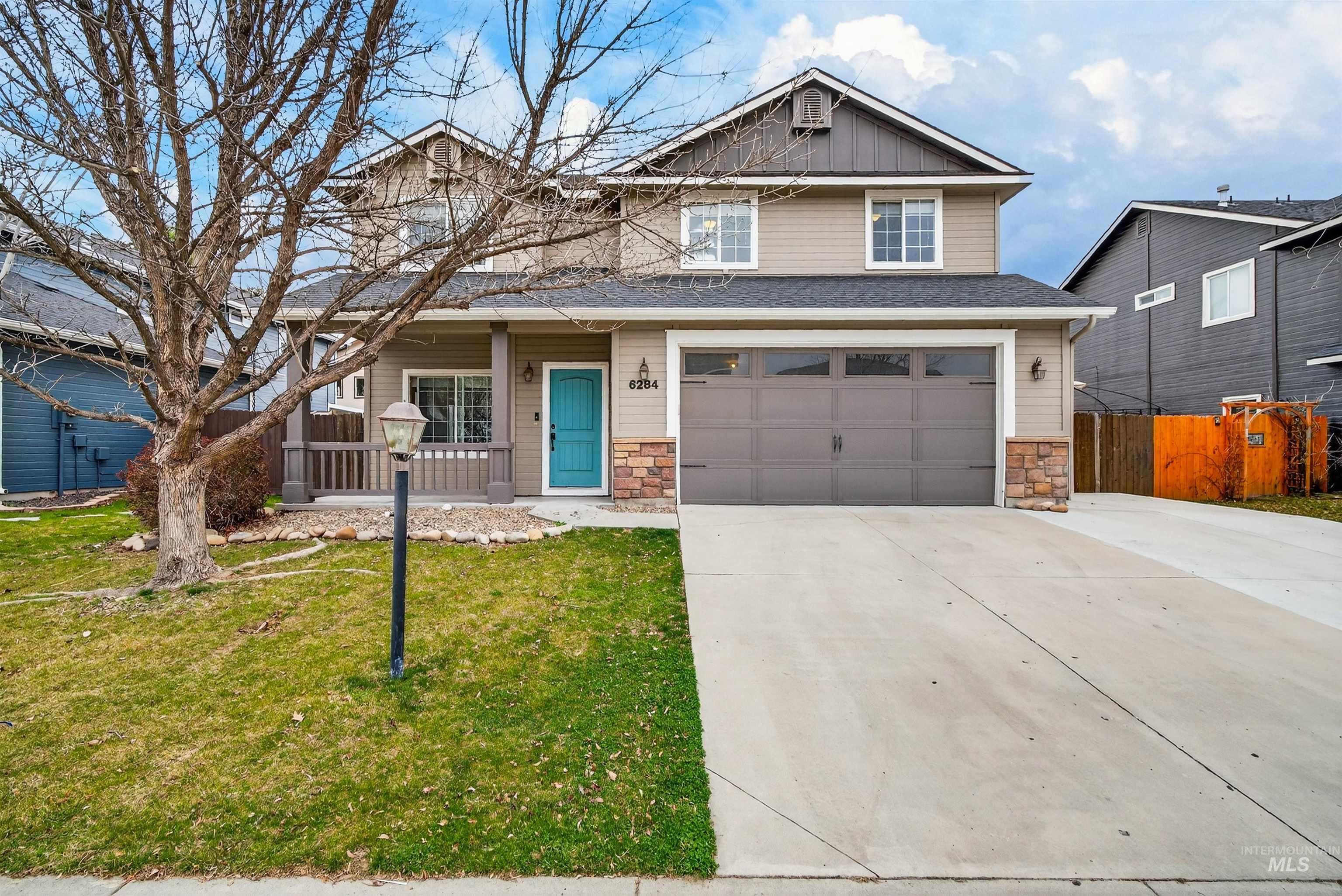 6284 North Silver Elm Way Meridian, ID 83646 - Photo 2 of 50 View of front of home with a porch, stone siding, driveway, an attached garage, and board and batten siding