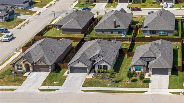 an aerial view of houses with a street