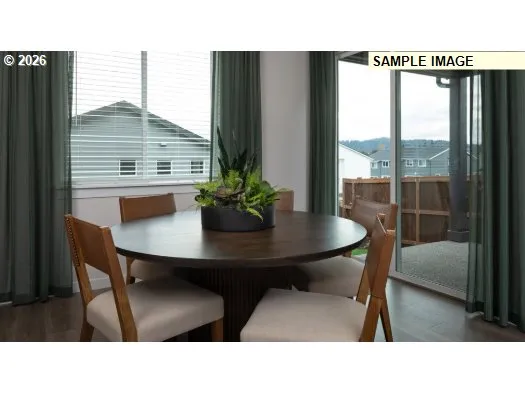 a kitchen view with a table and chairs in the patio