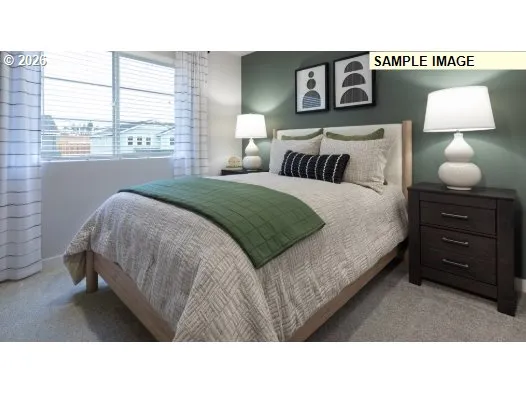 a bedroom with a bed and a lamp