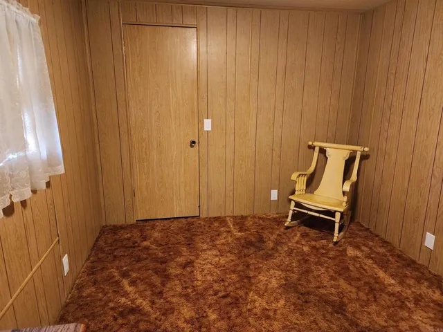 a view of a room with a bench and a chair