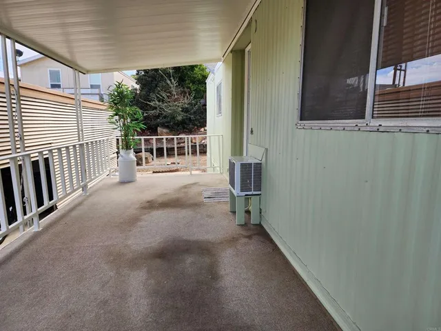 a balcony with wooden floor and fence