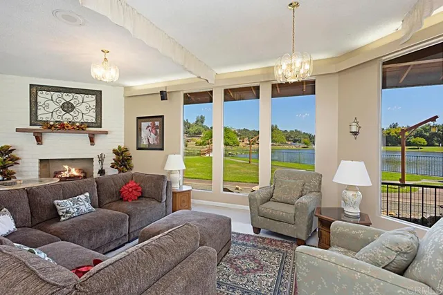 a dining room with furniture and a floor to ceiling window