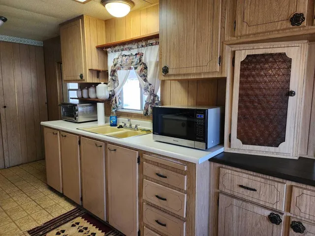 a kitchen with stainless steel appliances a stove microwave and cabinets
