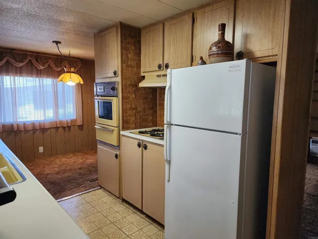 a kitchen with refrigerator and window