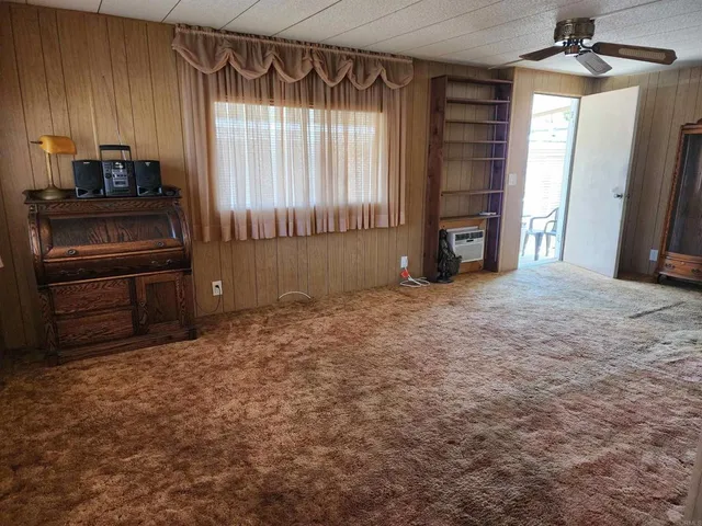 an empty room with furniture and windows